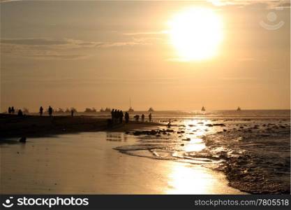 People on the beach and sunset in Mancora, Peru