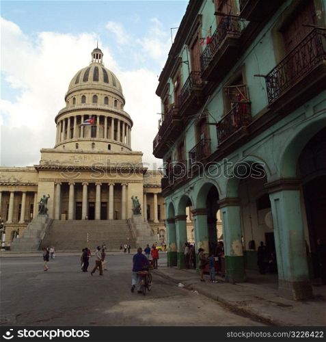 People on the street in front of the capitol building, Havana, Cuba