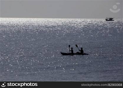 people paddle with a conoe Bay, Beach and Landscape at the Town of Sairee Village on the Ko Tao Island in the Province of Surat Thani in Thailand,  Thailand, Ko Tao, March, 2010. THAILAND SURAT THANI KO TAO ISLAND