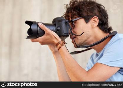 people, photography, technology and lifestyle - close up of photographer with digital camera shooting