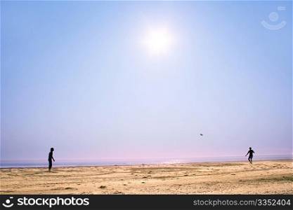 people playing frisbee on the sunshine beach