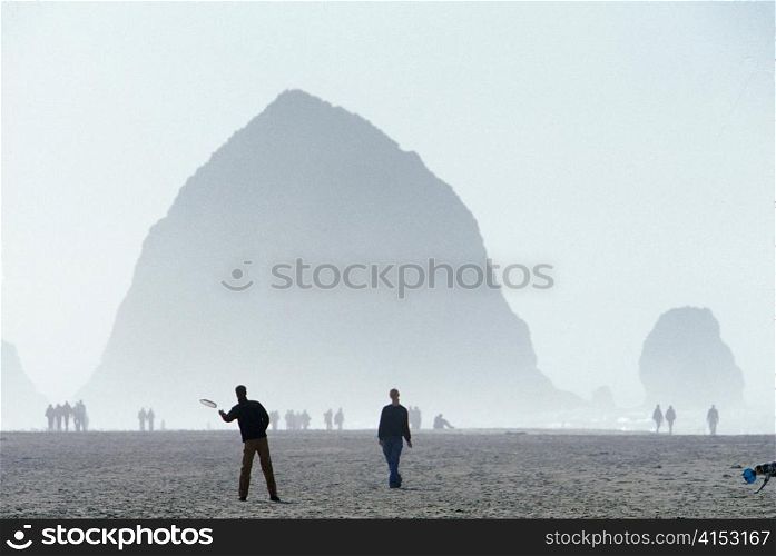 People Playing with Dog at Cannon Beach Oregon