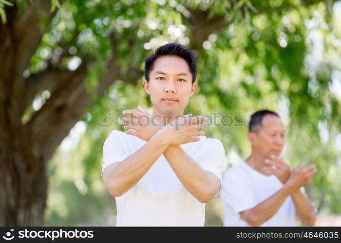 People practicing thai chi in park. People practicing thai chi in the park in the summertime