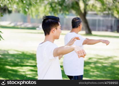 People practicing thai chi in park. People practicing thai chi in the park in the summertime