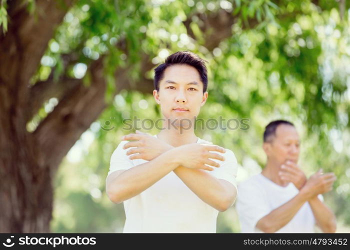 People practicing thai chi in park. People practicing thai chi in the park in the summertime