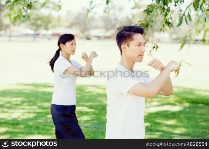 People practicing thai chi in park. People practicing thai chi in the park in the summertime