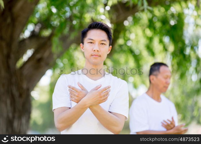 People practicing thai chi in park. People practicing thai chi in the park in the summertime