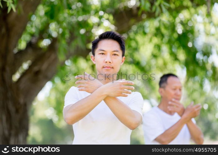 People practicing thai chi in park. People practicing thai chi in the park in the summertime