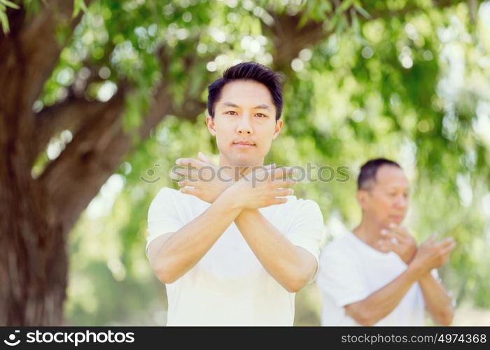 People practicing thai chi in park. People practicing thai chi in the park in the summertime