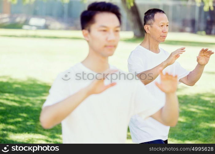 People practicing thai chi in park. People practicing thai chi in the park in the summertime