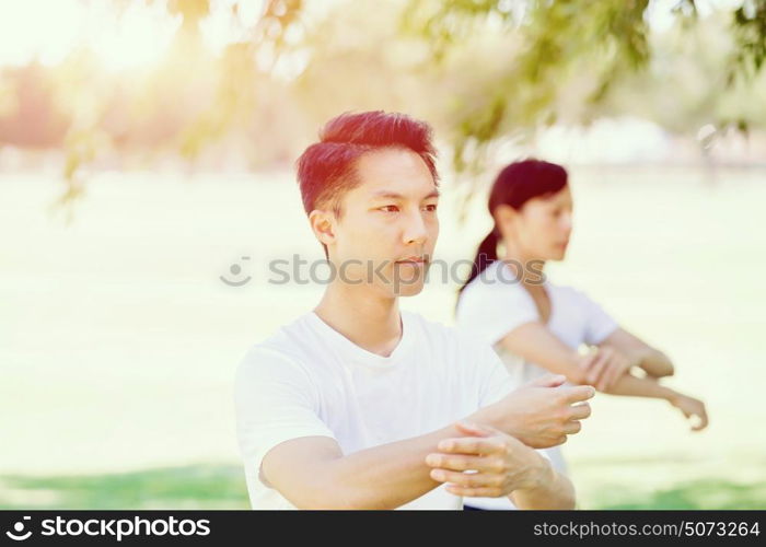 People practicing thai chi in park. People practicing thai chi in the park in the summertime