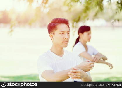 People practicing thai chi in park. People practicing thai chi in the park in the summertime