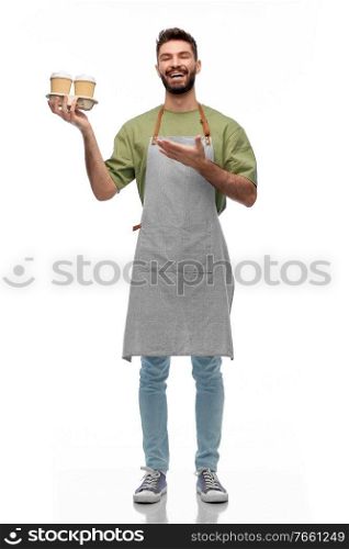 people, profession and job concept - happy smiling barman in apron holding takeaway coffee over white background. happy smiling barman in apron with takeaway coffee