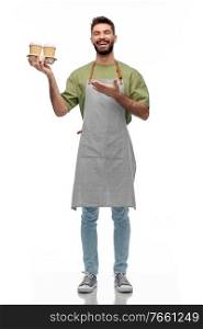 people, profession and job concept - happy smiling barman in apron holding takeaway coffee over white background. happy smiling barman in apron with takeaway coffee