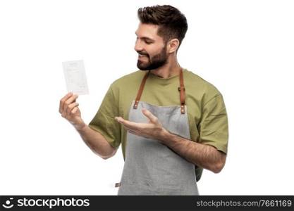 people, profession and job concept - happy smiling barman in apron with bill over white background. happy smiling barman in apron with bill