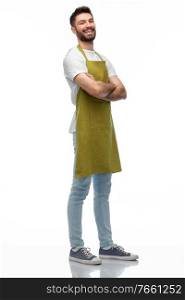 people, profession and job concept - happy smiling barman, waiter or gardener in apron with crossed arms over white background. happy barman or waiter in apron with crossed arms