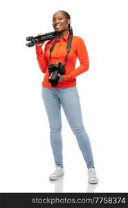 people, profession and photography concept - happy smiling woman photographer with digital camera and tripod over white background. happy smiling woman with digital camera and tripod