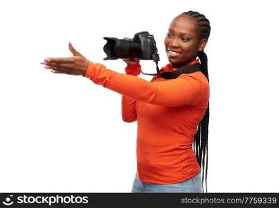 people, profession and photography concept - happy young woman with digital camera over white background. happy woman with digital camera