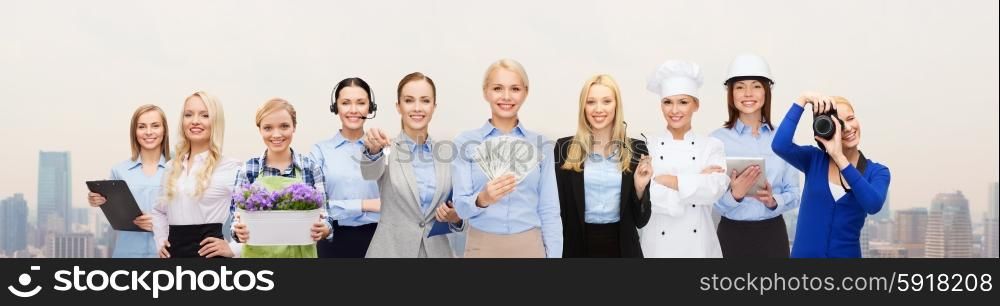 people, profession, employment, compensation and finances concept - happy businesswoman holding dollar money with group of professional workers over city background