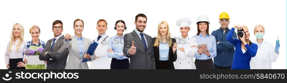 people, profession, qualification, employment and success concept - happy businessman over professional workers showing thumbs up