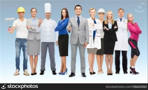 people, profession, qualification, employment and success concept - happy businessman with group of professional workers showing thumbs up over blue background