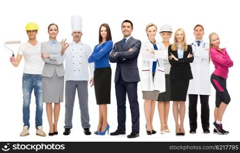 people, profession, qualification, employment and success concept - happy different businessman over group of professional workers