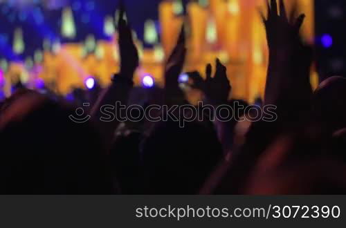 People put hands up enjoying the performance on the concert.