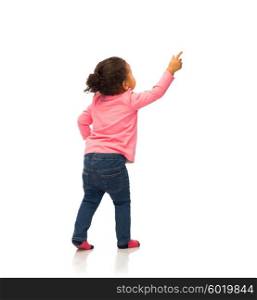 people, race, ethnicity and childhood concept - happy african american baby girl pointing finger to something from back