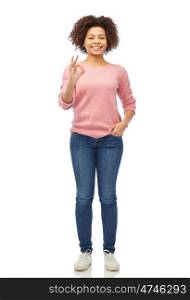 people, race, ethnicity and gesture concept - happy african american young woman showing ok hand sign over white