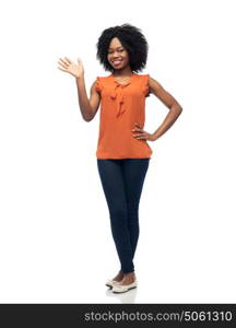 people, race, ethnicity and gesture concept - happy african american young woman waving hand over white. happy african woman waving hand over white