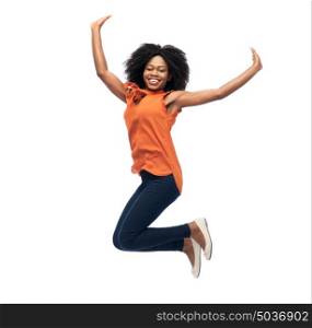 people, race, ethnicity and motion concept - happy african american young woman jumping over white. happy african american woman jumping over white
