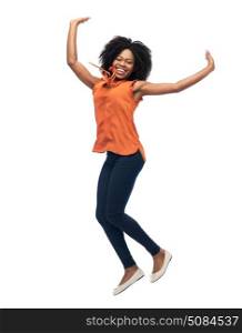 people, race, ethnicity and motion concept - happy african american young woman jumping over white. happy african american woman jumping over white. happy african american woman jumping over white