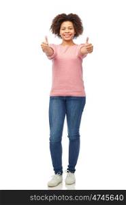 people, race, ethnicity and portrait concept - happy african american young woman showing thumbs up over white