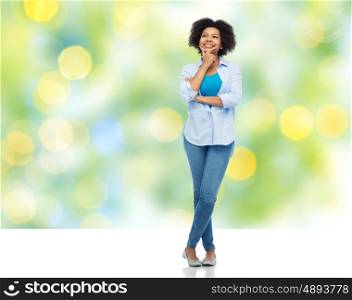 people, race, ethnicity and portrait concept - happy african american young woman over summer green lights background