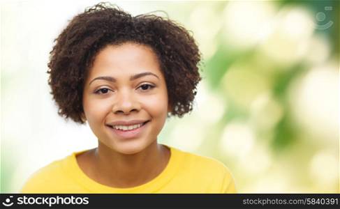 people, race, ethnicity and portrait concept - happy african american young woman face over green natural background