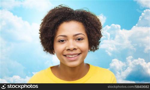 people, race, ethnicity and portrait concept - happy african american young woman face over blue sky with clouds background