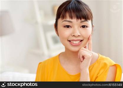 people, race, ethnicity and portrait concept - happy asian young woman or teenage girl face at home