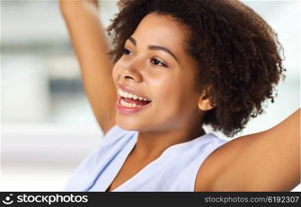 people, race, ethnicity and success concept - face of happy african american young woman celebrating victory