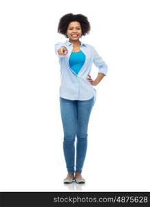 people, race, ethnicity, gesture and choice concept - happy african american young woman pointing finger to you over white