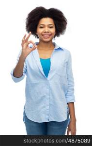 people, race, ethnicity, gesture and portrait concept - happy african american young woman showing ok hand sign over white
