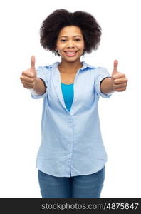 people, race, ethnicity, gesture and portrait concept - happy african american young woman showing thumbs up over white