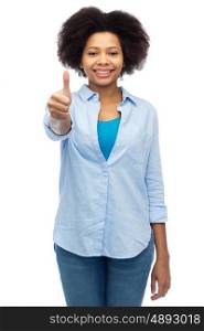 people, race, ethnicity, gesture and portrait concept - happy african american young woman showing thumbs up over white