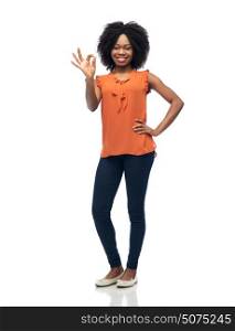 people, race, ethnicity, gesture and portrait concept - happy african american young woman showing ok hand sign over white. happy african american young woman over white