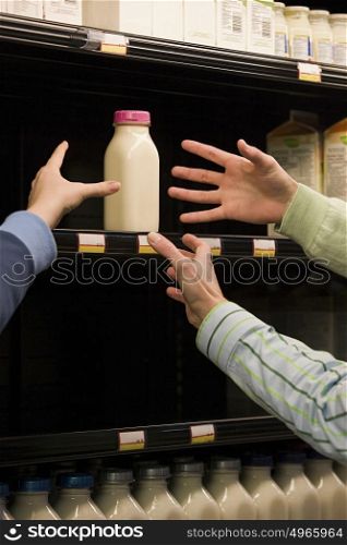 People reaching for milk