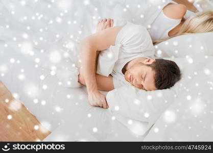 people, relationship difficulties, conflict and family concept - couple sleeping in bed at home over snow