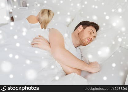 people, relationship difficulties, conflict and family concept - couple sleeping in bed at home over snow