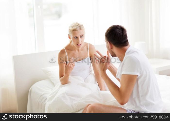 people, relationship difficulties, conflict and family concept - unhappy couple having argument at bedroom