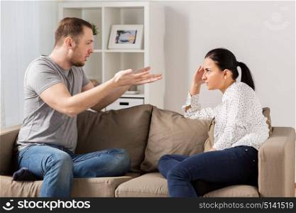 people, relationship difficulties, conflict and family concept - unhappy couple having argument at home. unhappy couple having argument at home