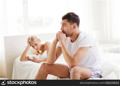people, relationship difficulties, conflict and family concept - unhappy couple having problems at bedroom