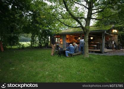 People relaxing outside a converted barn
